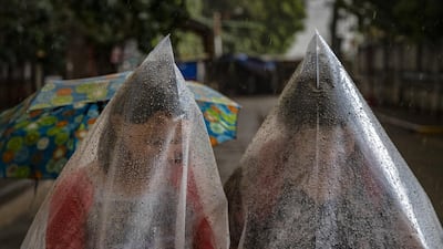Residents use plastic bags to shield themselves from ash mixed with rainwater as Taal Volcano erupts in Talisay, Batangas province, Philippines. Local authorities have begun evacuating residents near Taal Volcano as it began spewing ash up to a kilometre high Sunday afternoon. The Philippine Institute of Volcanology and Seismology has raised the alert level to three out of five, warning of the volcano's continued "magmatic unrest." Getty Images
