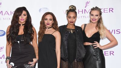 Jesy Nelson, in a black jumpsuit, with her Little Mix bandmates at the launch of their fragrance Wishmaker in England on July 27, 2016
