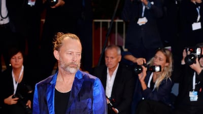 HIT: It is crazy, but this ombre blue silk suit works well on Radiohead singer Thom Yorke, complete with sandals and a man-bun.