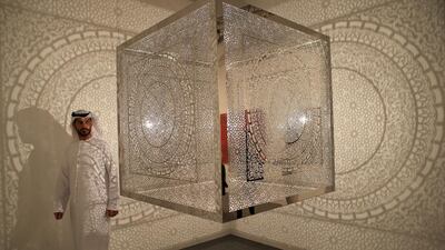 Art fan Ahmed al Abdouli inspects artist Anila Quayyum Agha’s Crossing Boundaries installation at Manarat Al Saadiyat in Abu Dhabi. The work is being shown as part of the seventh annual Abu Dhabi Art event. Ravindranath K / The National