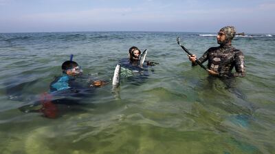 Palestinian spear-fishermen display fish at the Mediterranean Sea off the coast of the southern Gaza Strip. Reuters