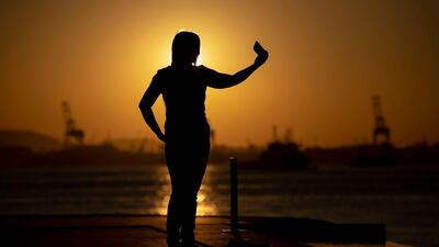 A woman takes a selfie in Rio de Janeiro. 259 people died while taking a selfie between October 2011 and November 2017 a study in India found. AFP