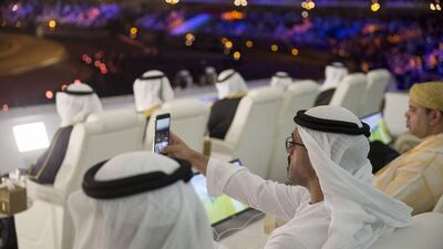 Sheikh Khaled bin Mohammed (C) takes a photo of the 44th UAE National Day celebrations at Zayed Sports City. Mohamed Al Hammadi / Crown Prince Court - Abu Dhabi
