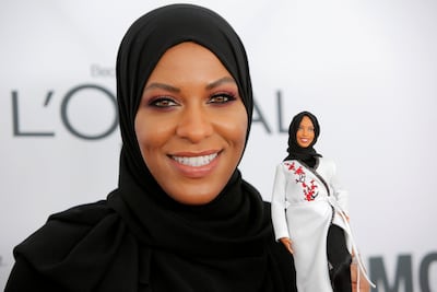 Olympic fencer Ibtihaj Muhammad holds a Barbie doll made in her likeness. /Andrew Kelly/Reuters