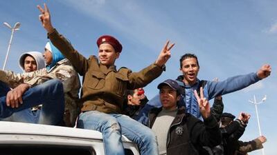 A boy wearing a military police uniform chants anti-government slogans in a street in Benghazi. Thousands of Libyans celebrated the liberation of the eastern city of Benghazi from the rule of Mr Qaddafi.