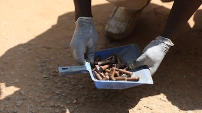A forensics officer examines bullet casings from the scene. AFP
