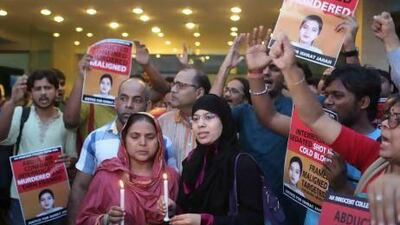 Ishrat Jahan's mother, Shamima Kauser (front left), and sister Nusrat (second from left), hold a candlelight vigil.