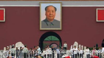 Athletes push past Tiananmen Gate as they compete during the men's marathon T54.