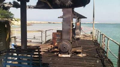 The burnt boat in Al Mirfa, from which a firefighter rescued a man and his son, 6.