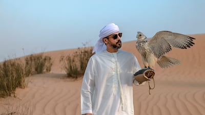 Falconer Ammar Al Marri prepares to hone his skills in the desert. Victor Besa / The National