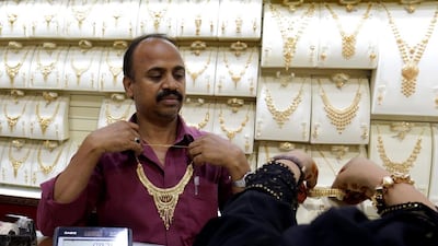 A salesman displays a gold necklace for a customer at a jewelry shop in the gold market of Souk Balad, which used to be the old city centre of Jeddah. Most of its original inhabitants left the city centre in the 70s when the oil prices soared.