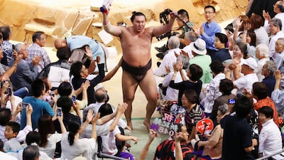 Mongolian-born sumo grand champion Hakuho receives the blessing from spectators after he established all-time sumo record with his 1,048th win, at the 13rd day of the 15-day Nagoya Grand Sumo Tournament at the Aichi Prefectural Gymnasium in Nagoya, central Japan on July 21, 2017. Reuters