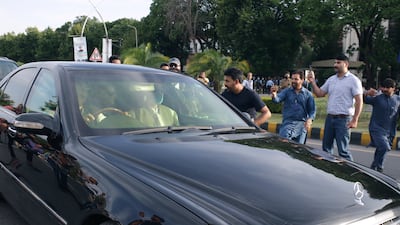 A car carrying Mr Khan arrives at the Supreme Court in Islamabad for his court appearance. AP