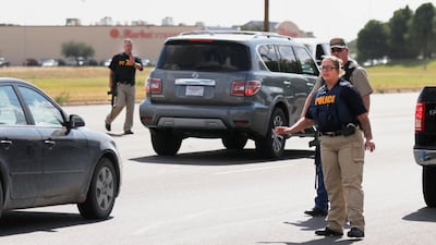 Authorities control traffic on the E. 42nd Street in Odessa, Texas. Several people were dead after a gunman who hijacked a postal service vehicle in West Texas shot more than 20 people, authorities said Saturday. The gunman was killed and a few law enforcement officers were among the injured. AP