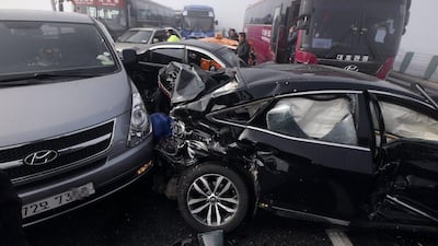 Damaged vehicles sit on Yeongjong Bridge in Incheon, South Korea. Two people were killed and at least 60 were injured on Wednesday after a pileup involving about 100 vehicles. Yonhap, Suh Myung-gon / AP