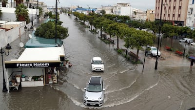 Cars drive through floodwaters in Tunis. EPA