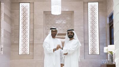 President Sheikh Mohamed and Sheikh Mohammed bin Rashid, Vice President and Ruler of Dubai, show off their Expo2020 wristbands at the graduation ceremony in 2019.
