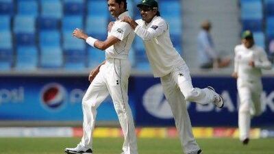 Umar Gul and Mohammed Hafeez celebrate the fall of England.