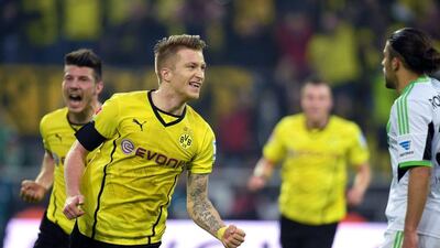 Borussia Dortmund player Marco Reus celebrates after scoring the winning goal during a Bundesliga match against Wolfsburg on Saturday. Bernd Thissen / EPA / April 5, 2014