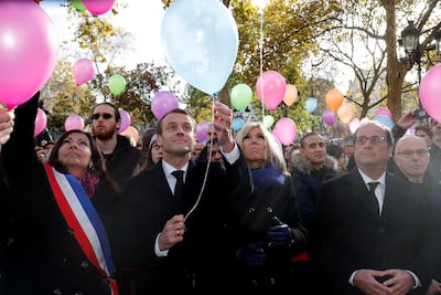 French President Emmanuel Macron released balloons during a ceremony held for the victims of the Paris attacks. Philippe Wojazer/ Reuters.