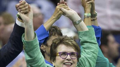 Tennis great Billie Jean King holds hands with other attendees during a lull in play between games as Serena Williams faced Venus Williams in the US Open quarter-finals on Tuesday. Carlo Allegri / Reuters