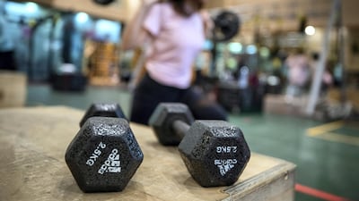 Ihsan Al Sakka does weight training and cardio exercises with his children at the Abu Dhabi Country Club. Victor Besa / The National