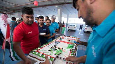 A worker receives a slice of cake.
