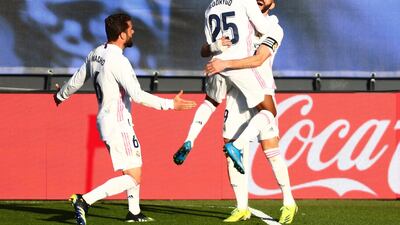 Real Madrid's Karim Benzema celebrates scoring their second goal with Rodrygo and Nacho against Elche at the Estadio Alfredo Di Stefano on Saturday, March 13. Reuters