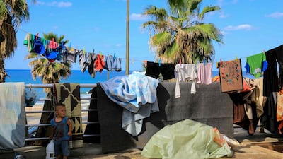 A displaced child outside a makeshift tent in Beirut's seaside promenade. AFP