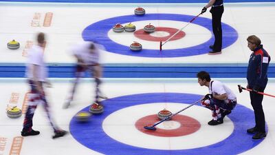 Germany's skip John Jahr, right, and Norway's skip Thomas Ulsrud, second right, looks at a shot in a match during their World Men's Curling Championships in Beijing on Tuesday. China Daily / Reuters / April 1, 2014