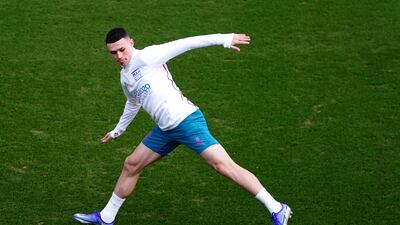 Phil Foden stretches for the ball. PA