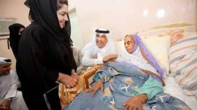 Khaled Al Kamda, director general of the Community Development Authority, centre, and other representatives of the organisation visit Maitha Khalfan Harib.