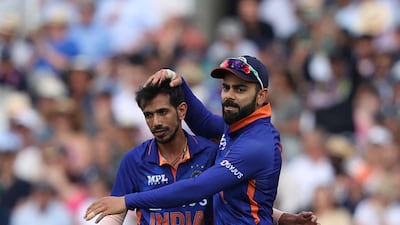 India's Yuzvendra Chahal celebrates with Virat Kohli after bowling England batsman Jonny Bairstow. AFP