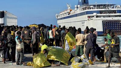 Migrants wait on the island of Lampedusa as Italian authorities prepare to transfer them on September 17. EPA