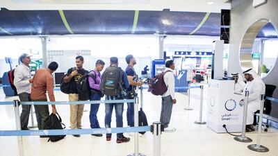 Passengers register for the newly implemented smart travel programme. Christopher Pike / The National