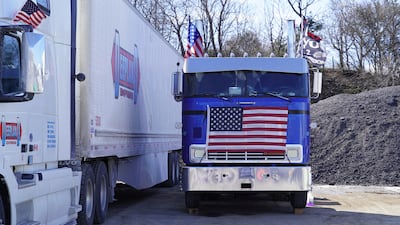 An American flag covers the grill of a lorry at the rally.