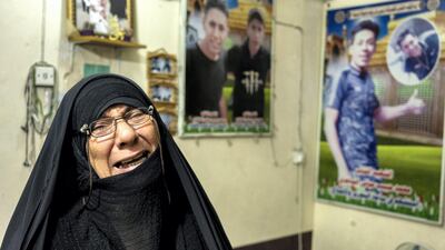 Habib Abbas Alsaadi, the mother of two men killed in the protests, cries while telling their story. Haider Husseini for The National