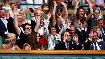 Catherine, Duchess of Cambridge and Prince William take part in a Mexican wave at the Wimbledon Lawn Tennis Championships in June 2011. Getty Images