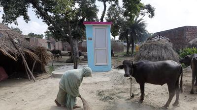 A woman brushes the floor next to her new toilet at Katra village in Badaun Uttar Pradesh, India. The toilets were built by Indian NGO Sulabh International within the scope of a nation-wide campaign 'Toilet for Every House' Marking the launch of the nation-wide campaign. Harish Tyagi / EPA