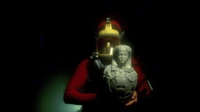 A diver with a 1st to 2nd century AD marble statue of Osiris retrieved from the lost city of Canopus, Egypt. Christoph Gerigk / Franck Goddio / Hilti Foundation
