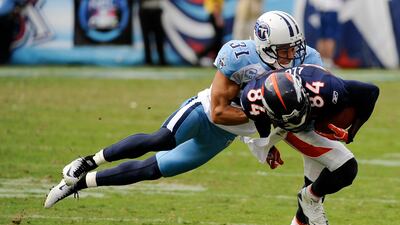 Tennessee Titans cornerback Cortland Finnegan (31) brings down Denver Broncos wide receiver Brandon Lloyd (84) in the fourth quarter of an NFL football game on Sunday, Sept. 25, 2011, in Nashville, Tennessee. The Titans won 17-14. Frederick Breedon / AP ???