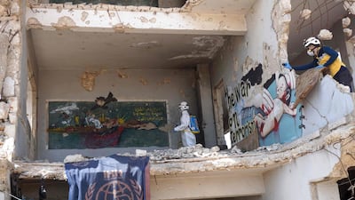 Civil defence volunteers, known as the White Helmets, disinfect a former school building occupied by displaced families in the rebel-held town of Binnish in Syria’s north-western Idlib province on March 26, 2020. AFP