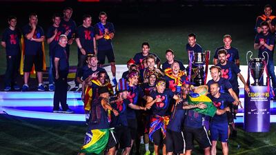 Barcelona players celebrate with La Liga, Copa del Rey and Champions League trophies during their victory parade after winning the UEFA Champions League Final at the Camp Nou Stadium on June 7, 2015 in Barcelona, Spain. (Photo by David Ramos/Getty Images)