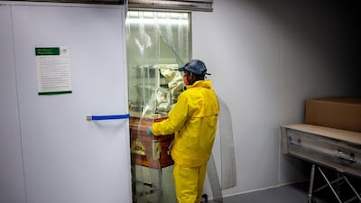 An undertaker pulls out the casket containing the remains of Steward Motlhabane, who died of Covid-19 coronavirus. AFP