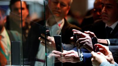 Visitors photograph the new Huawei Mate X foldable phone during the Mobile World Congress. EPA