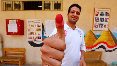 A man shows his ink-stained finger at a polling station in Cairo, Egypt. Reuters