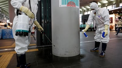 Sanitation workers spray disinfectant, as a precaution against coronavirus, at Suseo Station in Seoul. In China, 26 people have been killed by the virus. EPA