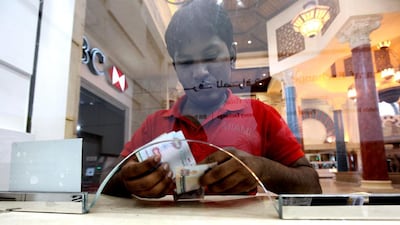 Tahir Mohammed, from Kerala, sends money home from Dubai’s Ibn Battuta Mall. The weak rupee has been a boon to Indians abroad. Pawan Singh / The National