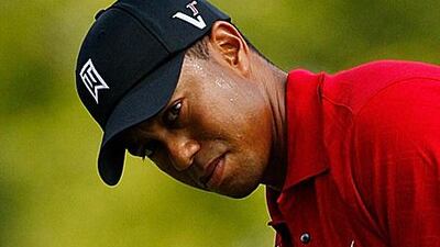 Tiger Woods watches a putt during the Buick Open in August. The PGA Tour lost the tournament from its calendar due to the recession.