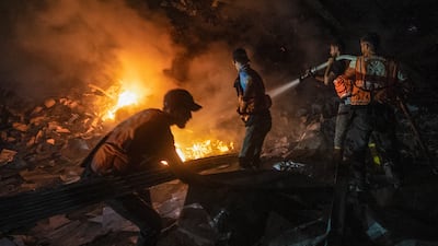 Palestinian firefighters battle a house blaze following an Israeli air strike in Gaza. EPA